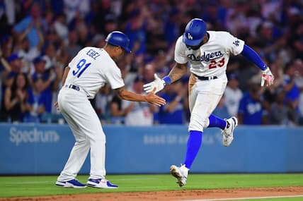 Aug 28, 2023; Los Angeles, California, USA; Los Angeles Dodgers right fielder Jason Heyward (23) is greeted by third base coach Dino Ebel (91) after hitting a two run home run against the Arizona Diamondbacks during the sixth inning at Dodger Stadium. Mandatory Credit: Gary A. Vasquez-USA TODAY Sports