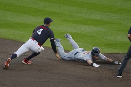 Aug 29, 2023; Minneapolis, Minnesota, USA; Cleveland Guardians first baseman Kole Calhoun (26) slides into second base for a double before Minnesota Twins shortstop Carlos Correa (4) can tag him in the third inning at Target Field. Mandatory Credit: Bruce Kluckhohn-USA TODAY Sports