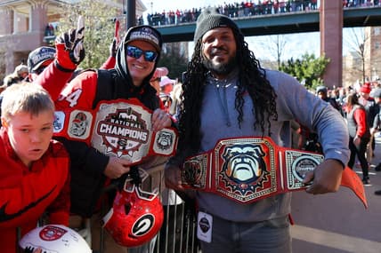 Jan 14, 2023; Athens, GA, USA; Georgia Bulldogs fan and assistant coach Jarvis Jones hold belts at the national championship celebration at Sanford Stadium. Mandatory Credit: Brett Davis-USA TODAY Sports