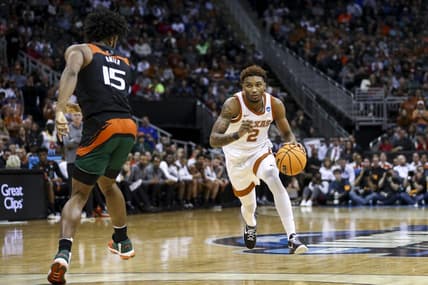 Mar 26, 2023; Kansas City, MO, USA;  Miami Hurricanes forward Norchad Omier (15) defends as Texas Longhorns guard Arterio Morris (2) dribbles the ball in the second half at the T-Mobile Center. Mandatory Credit: William Purnell-USA TODAY Sports