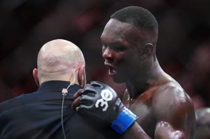 Apr 8, 2023; Miami, Florida, USA; Israel Adesanya (blue gloves) reacts to defeating Alex Pereira (red gloves) during UFC 287 at Miami-Dade Arena. Mandatory Credit: Rich Storry-USA TODAY Sports