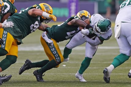 Jun 11, 2023; Edmonton, Alberta, CAN; Saskatchewan Roughriders running back Frankie Hickson (20) is tackled by Edmonton Elks linebacker Myles Morgan (45) during the second half at Commonwealth Stadium. Mandatory Credit: Perry Nelson-USA TODAY Sports