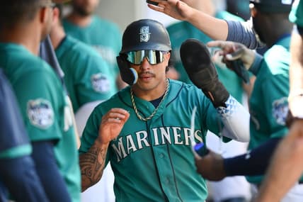 Jul 22, 2023; Seattle, Washington, USA; Seattle Mariners second baseman Kolten Wong (16) celebrates scoring a run against the Toronto Blue Jays in the seventh inning at T-Mobile Park. Mandatory Credit: Steven Bisig-USA TODAY Sports
