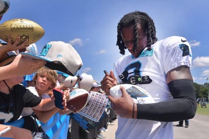 The Carolina Panthers and the New York Jets held a joint training camp practice at Wofford in Spartanburg on Aug. 9, 2023. Jaycee Horn (8) of the Carolina Panthers signs gear for fans.