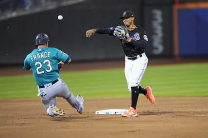 Sep 1, 2023; New York City, New York, USA; New York Mets shortstop Francisco Lindor (12) turns a double play with Seattle Mariners first baseman Ty France (23) sliding into second base during the second inning at Citi Field. Mandatory Credit: Gregory Fisher-USA TODAY Sports