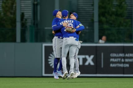 Sep 1, 2023; Denver, Colorado, USA; Toronto Blue Jays center fielder Kevin Kiermaier (39) and right fielder George Springer (4) and left fielder Daulton Varsho (25) celebrate after the game against the Colorado Rockies at Coors Field. Mandatory Credit: Isaiah J. Downing-USA TODAY Sports