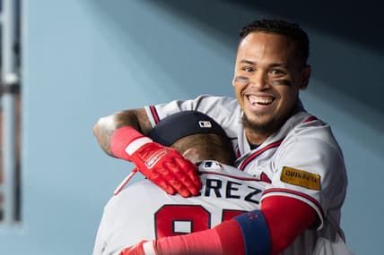 Sep 2, 2023; Los Angeles, California, USA; Atlanta Braves shortstop Orlando Arcia (11) celebrates with major league coach Eddie P  rez (95) in the dugout after hitting a triple RBI home run against the Los Angeles Dodgers during the 10th inning at Dodger Stadium. Mandatory Credit: Jonathan Hui-USA TODAY Sports