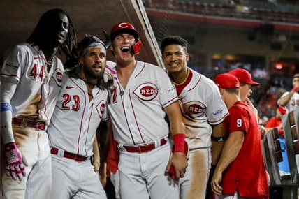 Sep 5, 2023; Cincinnati, Ohio, USA; Cincinnati Reds pinch hitter Nick Martini (23) reacts after hitting a three-run home run with shortstop Elly De La Cruz (44), pinch hitter Tyler Stephenson (37) and third baseman Noelvi Marte (16) in the eighth inning against the Seattle Mariners at Great American Ball Park. Mandatory Credit: Katie Stratman-USA TODAY Sports