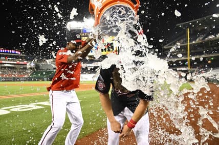 Sep 6, 2023; Washington, District of Columbia, USA; Washington Nationals outfielder Jacob Young (30) is doused with water by Washington Nationals outfielder Victor Robles (16) after hitting a walk off RBI single against the New York Mets during the ninth inning at Nationals Park. Mandatory Credit: Brad Mills-USA TODAY Sports