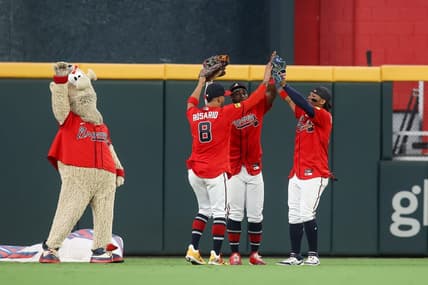 Sep 8, 2023; Atlanta, Georgia, USA; Atlanta Braves mascot Blooper and left fielder Eddie Rosario (8) and center fielder Michael Harris II (23) and right fielder Ronald Acuna Jr. (13) celebrate after a victory against the Pittsburgh Pirates at Truist Park. Mandatory Credit: Brett Davis-USA TODAY Sports