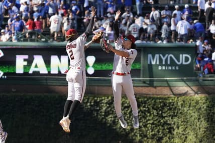 Sep 9, 2023; Chicago, Illinois, USA; Arizona Diamondbacks second baseman Geraldo Perdomo (2) and outfielder Alek Thomas (5) celebrate their win against the Chicago Cubs at Wrigley Field. Mandatory Credit: David Banks-USA TODAY Sports