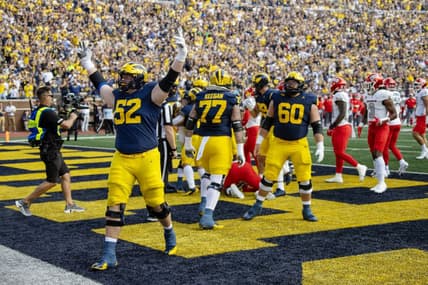Sep 9, 2023; Ann Arbor, Michigan, USA; Michigan Wolverines defensive end Kechaun Bennett (52) celebrates running back Blake Corum   s (2) touchdown during the first half at Michigan Stadium. Mandatory Credit: David Reginek-USA TODAY Sports