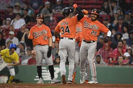 Sep 9, 2023; Boston, Massachusetts, USA;  Baltimore Orioles center fielder Aaron Hicks (34) is greeted at home plate by right fielder Anthony Santander (25) after hitting a three run home run during the third inning against the Boston Red Sox at Fenway Park. Mandatory Credit: Bob DeChiara-USA TODAY Sports