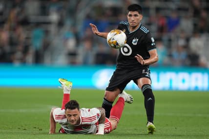 Sep 9, 2023; Saint Paul, Minnesota, USA;  New England Revolution forward Giacomo Vrioni (9) and Minnesota United defender Miguel Tapias (4) battle for the ball during the first half at Allianz Field. Mandatory Credit: Matt Blewett-USA TODAY Sports