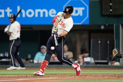 Sep 9, 2023; Arlington, Texas, USA; Texas Rangers first baseman Nathaniel Lowe (30) hits an RBI single against the Oakland Athletics during the sixth inning at Globe Life Field. Mandatory Credit: Jim Cowsert-USA TODAY Sports