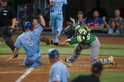 Sep 10, 2023; Arlington, Texas, USA; Texas Rangers shortstop Corey Seager (5) slides past the tag of Oakland Athletics catcher Tyler Soderstrom (37) during the fifth inning at Globe Life Field. Mandatory Credit: Jerome Miron-USA TODAY Sports