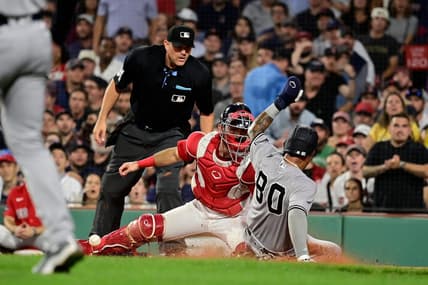 Sep 12, 2023; Boston, Massachusetts, USA; New York Yankees left fielder Everson Pereira (80) slides safe into home plate covered by Boston Red Sox catcher Connor Wong (12) during the fifth inning at Fenway Park. Mandatory Credit: Eric Canha-USA TODAY Sports