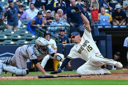 Sep 14, 2023; Milwaukee, Wisconsin, USA; Milwaukee Brewers left fielder Tyrone Taylor (15) scores past Miami Marlins catcher Jacob Stallings (58) in the fifth inning at American Family Field. Mandatory Credit: Benny Sieu-USA TODAY Sports