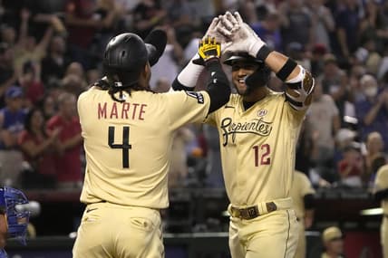 Sep 15, 2023; Phoenix, Arizona, USA; Arizona Diamondbacks left fielder Lourdes Gurriel Jr. (12) celebrates with second baseman Ketel Marte (4) after hitting a three run home run against the Chicago Cubs in the first inning at Chase Field. Mandatory Credit: Rick Scuteri-USA TODAY Sports