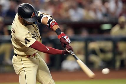 Sep 16, 2023; Phoenix, Arizona, USA; Arizona Diamondbacks left fielder Lourdes Gurriel Jr. (12) hits an RBI single against the Chicago Cubs during the fourth inning at Chase Field. Mandatory Credit: Joe Camporeale-USA TODAY Sports