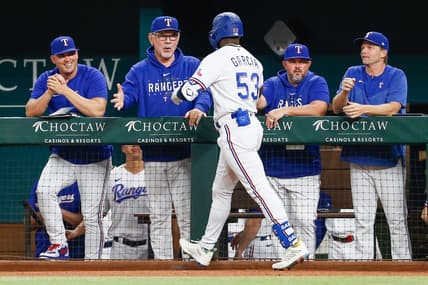 Sep 19, 2023; Arlington, Texas, USA; Texas Rangers manager Bruce Bochy (15) shakes hands with right fielder Adolis Garcia after he hits a home run during the second inning against the Boston Red Sox at Globe Life Field. Mandatory Credit: Andrew Dieb-USA TODAY Sports