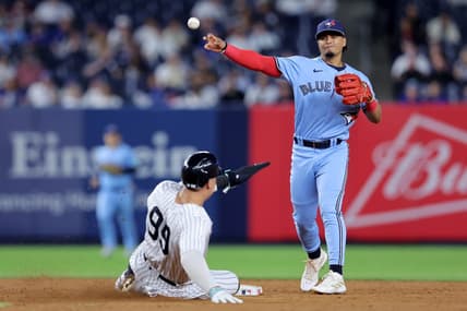 Sep 19, 2023; Bronx, New York, USA; Toronto Blue Jays second baseman Santiago Espinal (5) forces out New York Yankees right fielder Aaron Judge (99) at second and throws to first to complete a game ending double play on a ball hit by Yankees designated hitter Giancarlo Stanton (not pictured) during the ninth inning at Yankee Stadium. Mandatory Credit: Brad Penner-USA TODAY Sports