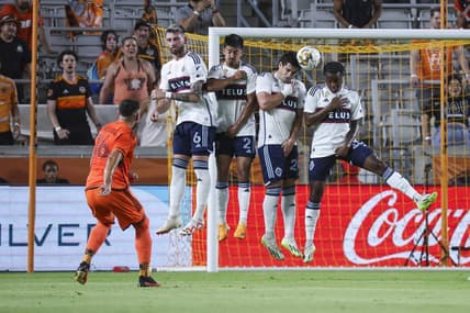 Sep 20, 2023; Houston, Texas, USA; Houston Dynamo FC midfielder Hector Herrera (16) shoots the ball past Vancouver Whitecaps FC defenders to score a goal during the first half at Shell Energy Stadium. Mandatory Credit: Troy Taormina-USA TODAY Sports