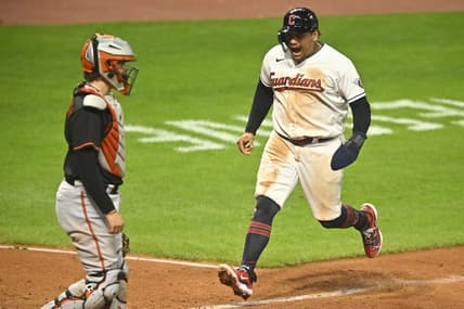Sep 22, 2023; Cleveland, Ohio, USA; Cleveland Guardians first baseman Josh Naylor (22) scores beside Baltimore Orioles catcher Adley Rutschman (35) in the seventh inning at Progressive Field. Mandatory Credit: David Richard-USA TODAY Sports