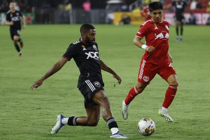 Sep 23, 2023; Washington, District of Columbia, USA; D.C. United defender Ruan (2) passes the ball as New York Red Bulls midfielder Omir Fernandez (21) chases in the first half at Audi Field. Mandatory Credit: Geoff Burke-USA TODAY Sports