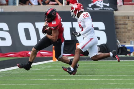 Sep 30, 2023; Lubbock, Texas, USA; Texas Tech Red Raiders tight end Mason Tharp (80) rushes against Houston Cougars defensive safety Antonio Brooks (20) in the first half at Jones AT&T Stadium and Cody Campbell Field. Mandatory Credit: Michael C. Johnson-USA TODAY Sports