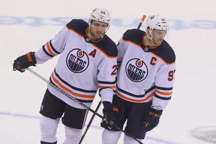 Dec 31, 2021; Newark, New Jersey, USA; Edmonton Oilers center Leon Draisaitl (29) and Edmonton Oilers center Connor McDavid (97) talk during overtime of their game against the New Jersey Devils at Prudential Center. Mandatory Credit: Ed Mulholland-USA TODAY Sports