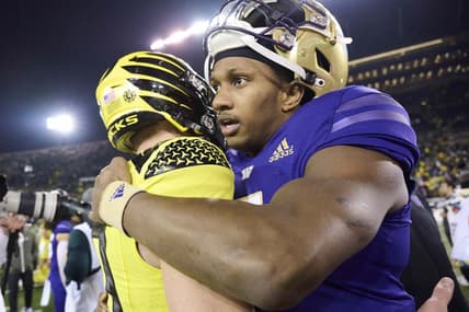 Nov 12, 2022; Eugene, Oregon, USA; Washington Huskies quarterback Michael Penix Jr. (9) embraces Oregon Ducks quarterback Bo Nix (10) after a game at Autzen Stadium. The Huskies won the game 37-34.  Mandatory Credit: Troy Wayrynen-USA TODAY Sports