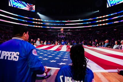 Apr 8, 2023; Los Angeles, California, USA; LA Clippers fans hold the American flag during a pre-game ceremony against the Portland Trail Blazers at Crypto.com Arena. Mandatory Credit: Jonathan Hui-USA TODAY Sports