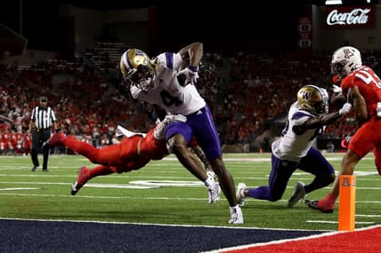 Sep 30, 2023; Tucson, Arizona, USA; Washington Huskies wide receiver Germie Bernard (4) scores a touchdown in the first half at Arizona Stadium. Mandatory Credit: Zachary BonDurant-USA TODAY Sports