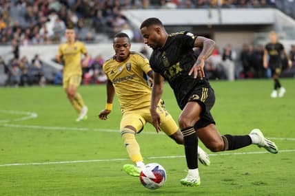 Oct 1, 2023; Los Angeles, California, USA;  Los Angeles FC defender Diego Palacios (12) dribbles the ball against Real Salt Lake forward Carlos Andres Gomez (11) during the first half at BMO Stadium. Mandatory Credit: Kiyoshi Mio-USA TODAY Sports