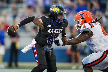 Sep 8, 2023; Lawrence, Kansas, USA; Kansas Jayhawks quarterback Jalon Daniels (6) against Illinois Fighting Illini defensive lineman Jer'Zhan Newton (4) during the first half at David Booth Kansas Memorial Stadium. Mandatory Credit: Jay Biggerstaff-USA TODAY Sports