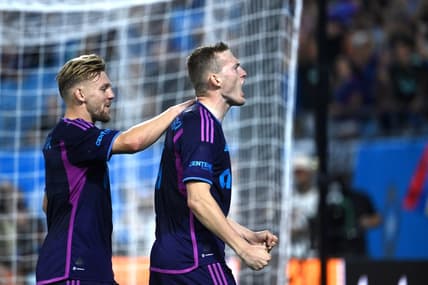 Oct 4, 2023; Charlotte, North Carolina, USA; Charlotte FC forward Karol   widerski (11) celebrates with midfielder Kamil J    wiak (7) after scoring his second goal in the first half at Bank of America Stadium. Mandatory Credit: Bob Donnan-USA TODAY Sports
