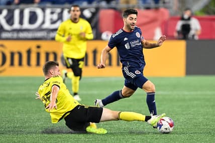 Oct 4, 2023; Foxborough, Massachusetts, USA; Columbus Crew midfielder Sean Zawadzki (25) defends New England Revolution midfielder Carles Gil (10) during the first half at Gillette Stadium. Mandatory Credit: Brian Fluharty-USA TODAY Sports