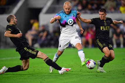 Oct 4, 2023; Los Angeles, California, USA; Los Angeles FC defender Sergi Palencia (30) and defender Giorgio Chiellini (14) play for the ball against Minnesota United forward Teemu Pukki (22) during the first half at BMO Stadium. Mandatory Credit: Gary A. Vasquez-USA TODAY Sports