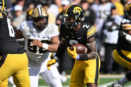Oct 7, 2023; Iowa City, Iowa, USA; Iowa Hawkeyes running back Kaleb Johnson (2) runs the ball as Purdue Boilermakers defensive lineman Mo Omonode (92) pursues during the first quarter at Kinnick Stadium. Mandatory Credit: Jeffrey Becker-USA TODAY Sports
