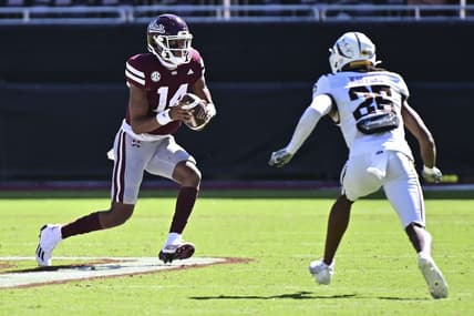 Oct 7, 2023; Starkville, Mississippi, USA; Mississippi State Bulldogs quarterback Mike Wright (14) runs the ball while defended by Western Michigan Broncos cornerback Aaron Wofford (25) during the fourth quarter at Davis Wade Stadium at Scott Field. Mandatory Credit: Matt Bush-USA TODAY Sports