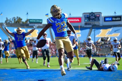 Oct 7, 2023; Pasadena, California, USA; UCLA Bruins wide receiver Keegan Jones (22) scores a touchdown against the Washington State Cougars during the second half at Rose Bowl. Mandatory Credit: Gary A. Vasquez-USA TODAY Sports