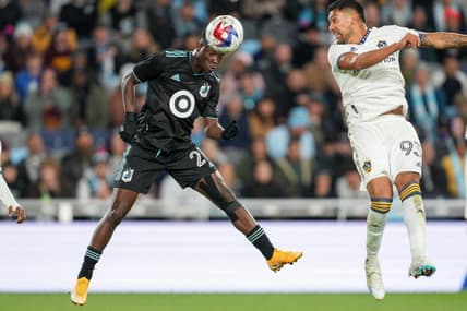 Oct 7, 2023; Saint Paul, Minnesota, USA; Minnesota United forward Bongokuhle Hlongwane (21) heads the ball against Los Angeles Galaxy defender Tony Alfaro (93) in the first half at Allianz Field. Mandatory Credit: Matt Blewett-USA TODAY Sports