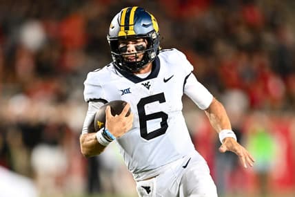 Oct 12, 2023; Houston, Texas, USA; West Virginia Mountaineers quarterback Garrett Greene (6) runs the ball in for a touchdown during the fourth quarter against the Houston Cougars  at TDECU Stadium. Mandatory Credit: Maria Lysaker-USA TODAY Sports