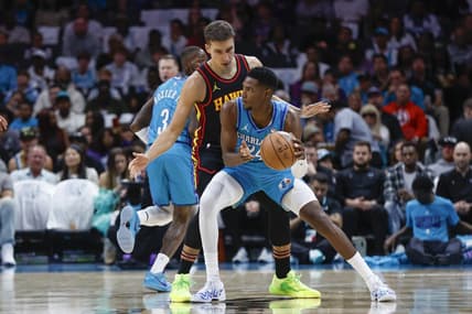 Oct 25, 2023; Charlotte, North Carolina, USA; Charlotte Hornets forward Brandon Miller (24) looks to pass around Atlanta Hawks guard Bogdan Bogdanovic (13) during the first quarter at Spectrum Center. Mandatory Credit: Nell Redmond-USA TODAY Sports