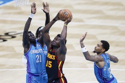 Oct 25, 2023; Charlotte, North Carolina, USA; Atlanta Hawks center Clint Capela (15) drives to the basket between Charlotte Hornets forwards JT Thor and  P.J. Washington (25) during the second quarter at Spectrum Center. Mandatory Credit: Nell Redmond-USA TODAY Sports