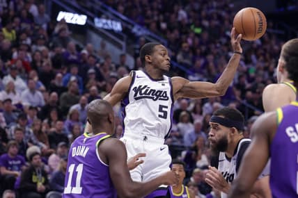 Oct 25, 2023; Salt Lake City, Utah, USA;  Sacramento Kings guard De'Aaron Fox (5) passes the ball away from Utah Jazz guard Kris Dunn (11) during the second quarter at Delta Center. Mandatory Credit: Chris Nicoll-USA TODAY Sports