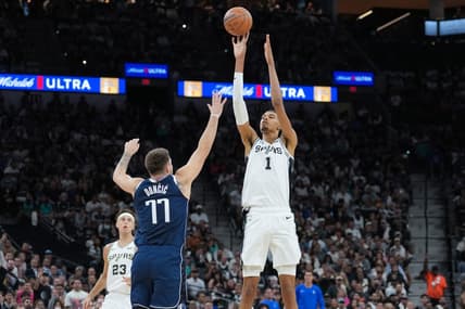 Oct 25, 2023; San Antonio, Texas, USA; San Antonio Spurs center Victor Wembanyama (1) shoots over Dallas Mavericks guard Luka Doncic (77) in the first half at the Frost Bank Center. Mandatory Credit: Daniel Dunn-USA TODAY Sports