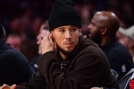 Oct 26, 2023; Los Angeles, California, USA; Phoenix Suns guard Devin Booker (1) watches game action against the Los Angeles Lakers during the first half at Crypto.com Arena. Mandatory Credit: Gary A. Vasquez-USA TODAY Sports