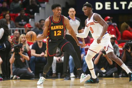 Oct 27, 2023; Atlanta, Georgia, USA; Atlanta Hawks forward De'Andre Hunter (12) is defended by New York Knicks guard RJ Barrett (9) in the first quarter at State Farm Arena. Mandatory Credit: Brett Davis-USA TODAY Sports